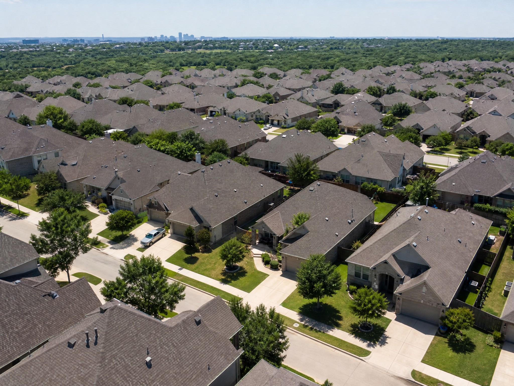 Suburban Central Texas neighborhood with uniform roof styles in an HOA