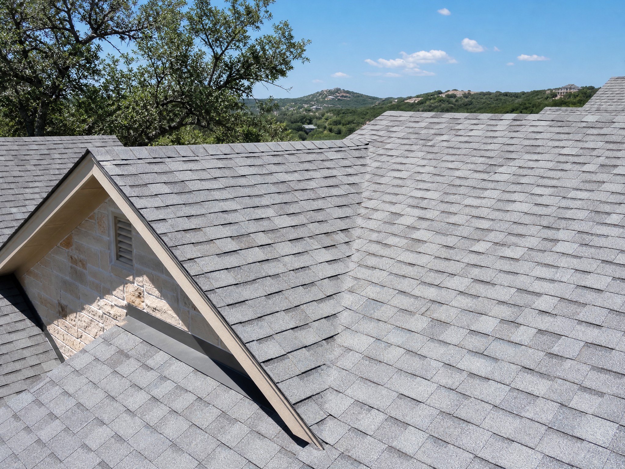 Light-colored shingle roof reflecting sun on a Central Texas home