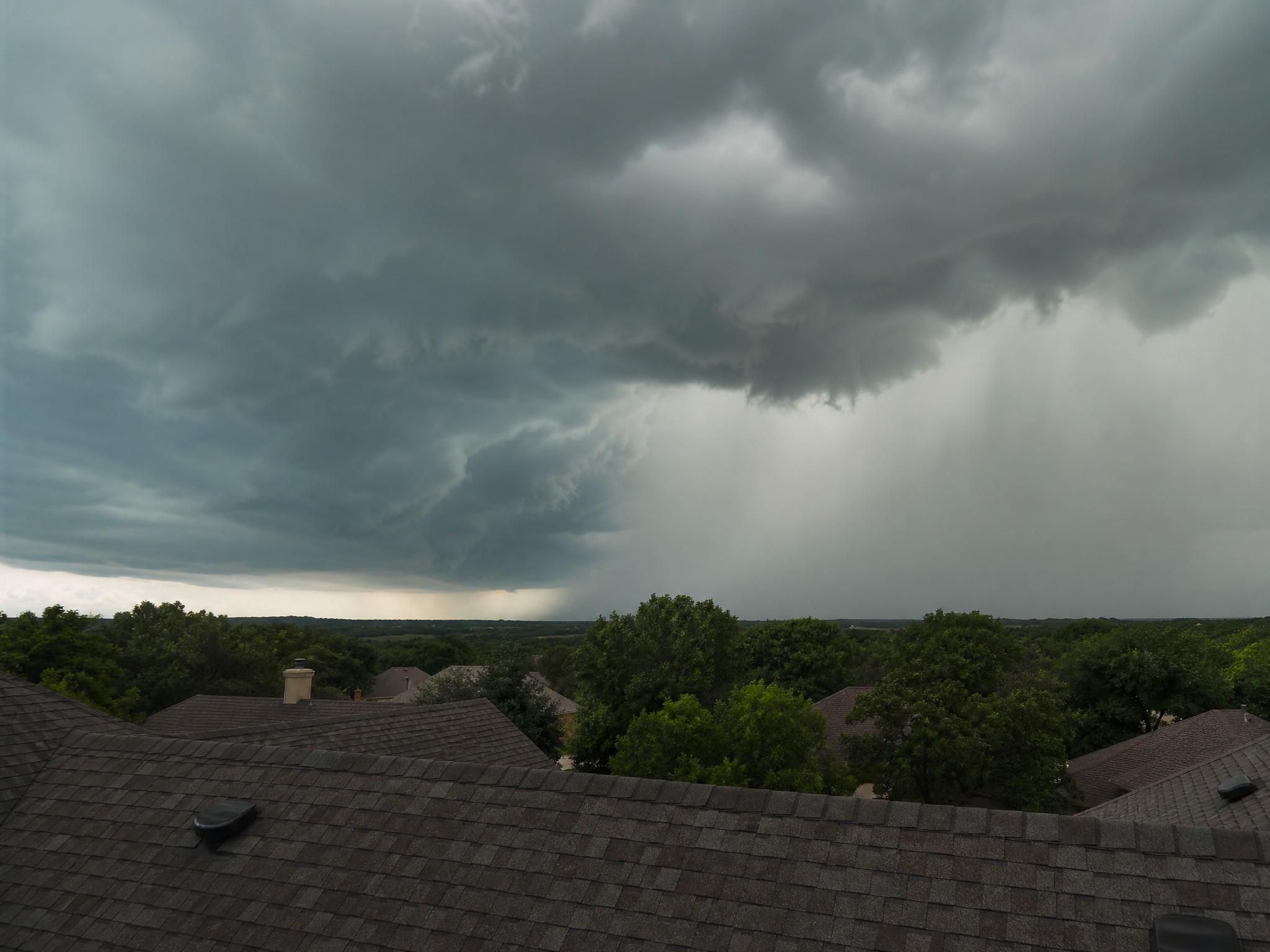 Dark storm clouds gathering over a Central Texas neighborhood